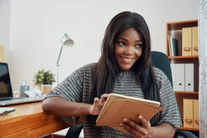 smiling woman working utilizing internet on tablet