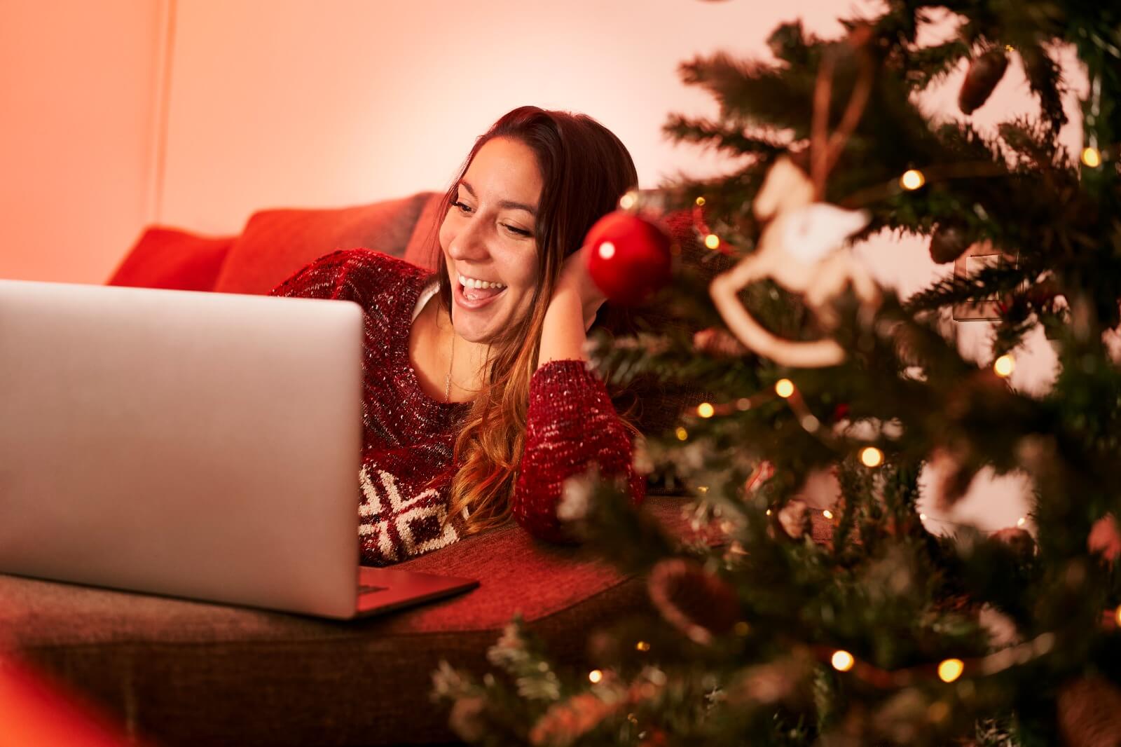 happy woman looking at christmas shopping deals