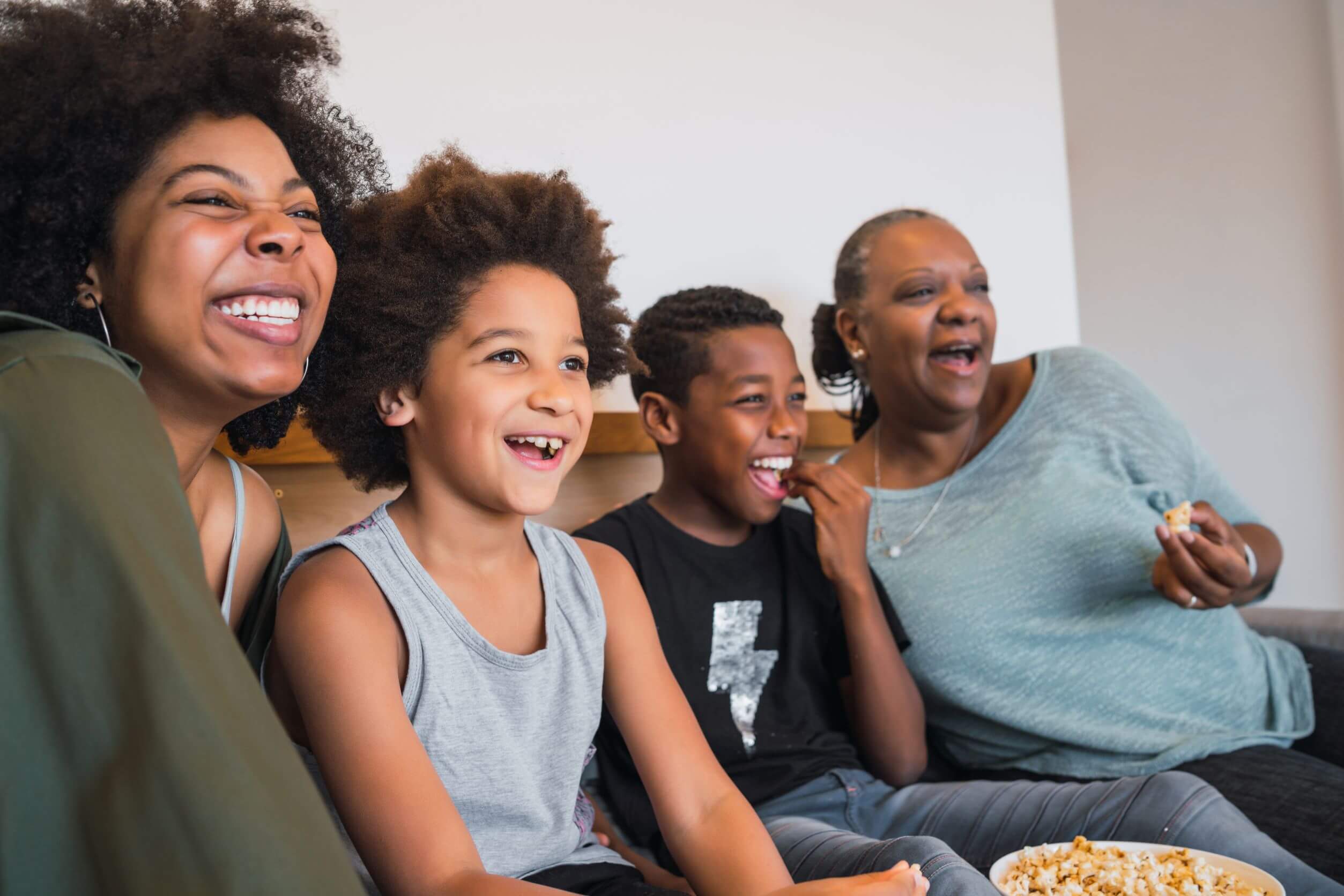 Grandmother mother and children watching a movie