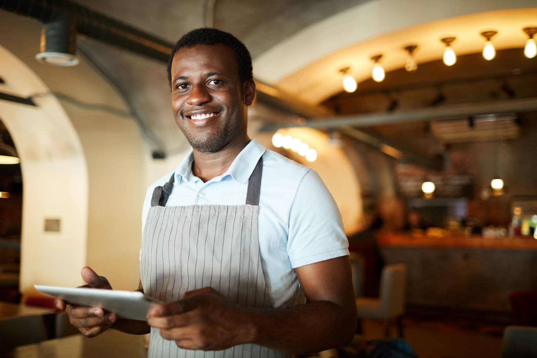 Waiter in restaurant with iPad