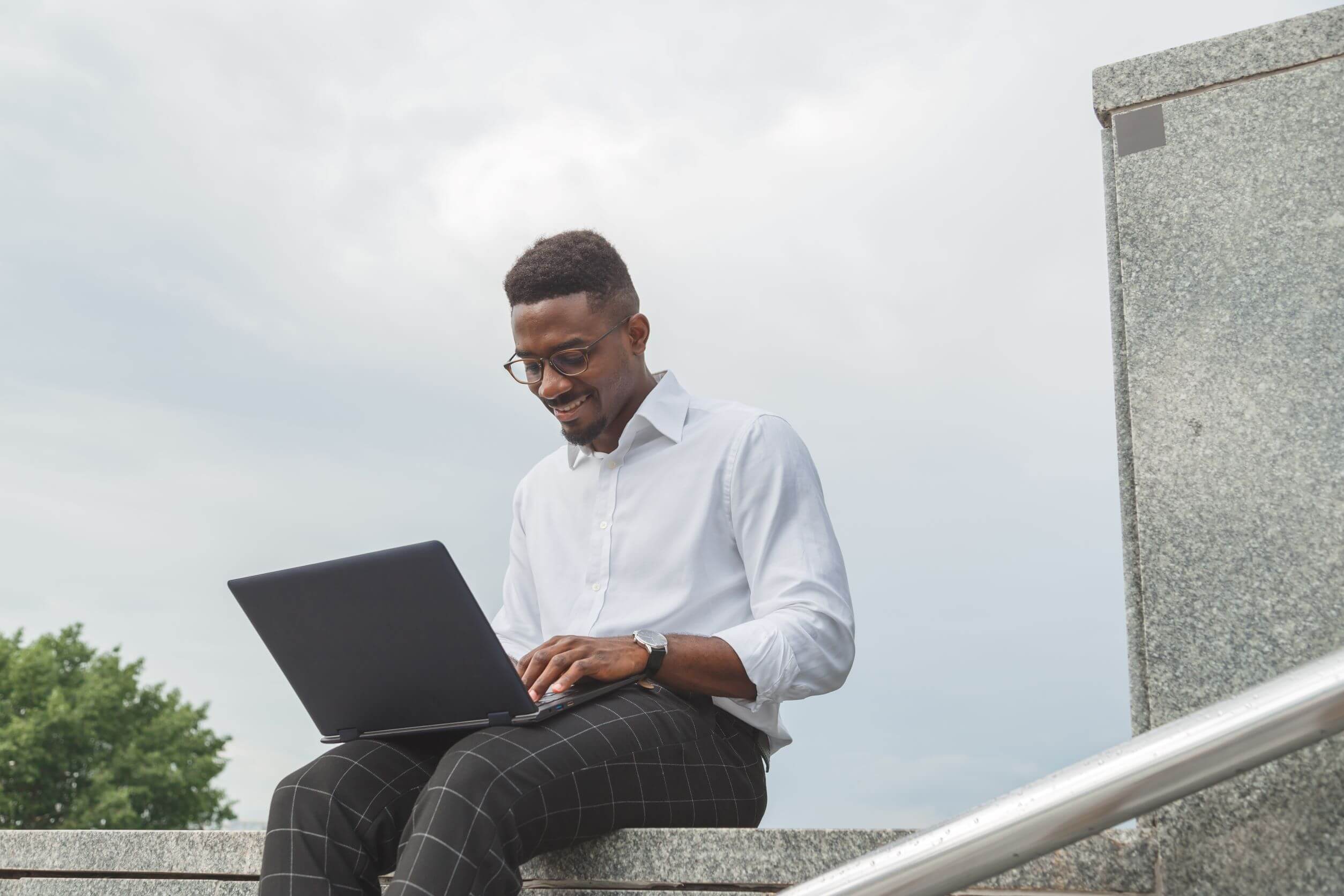 handsome young businessman working with laptop out