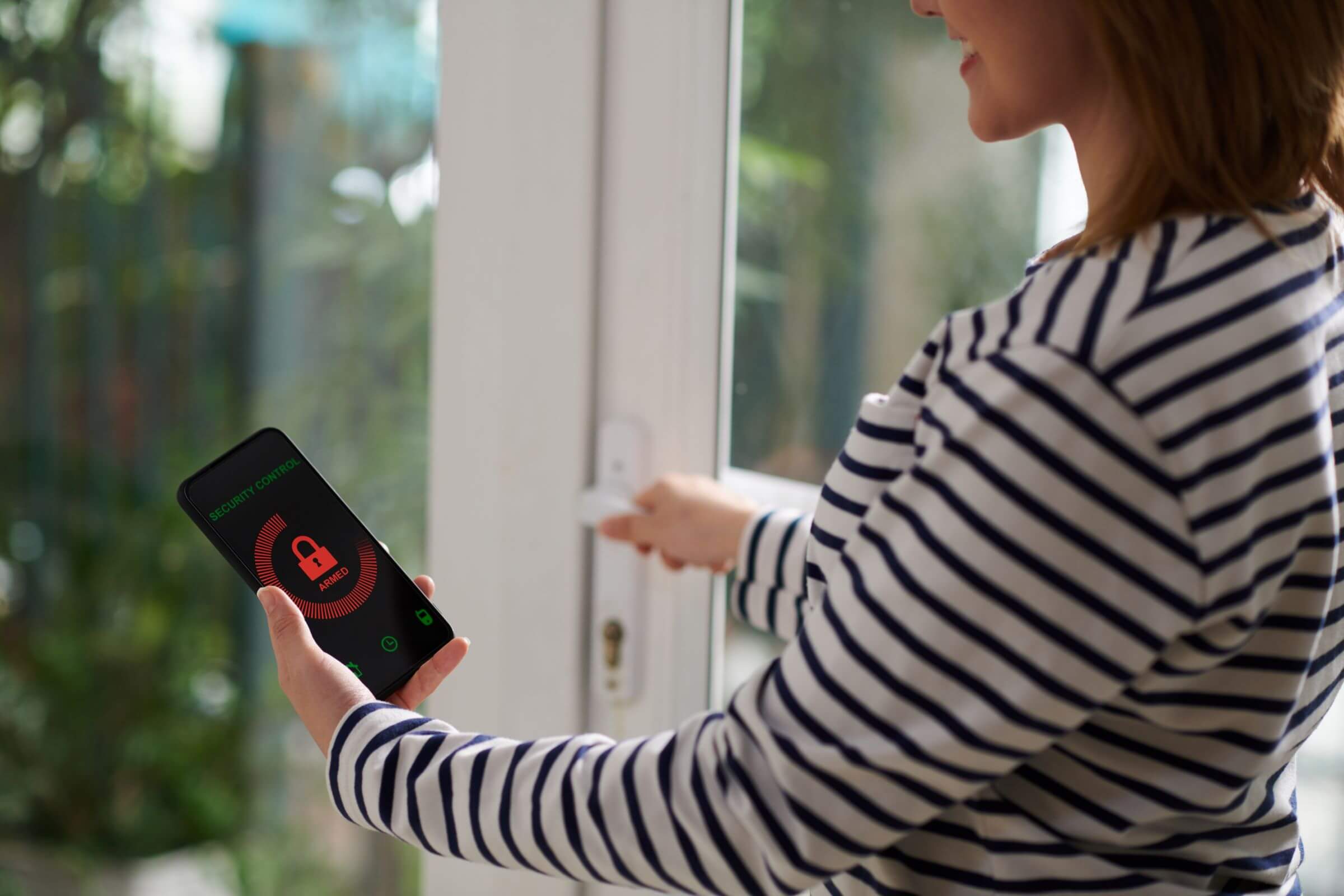 woman setting home security system