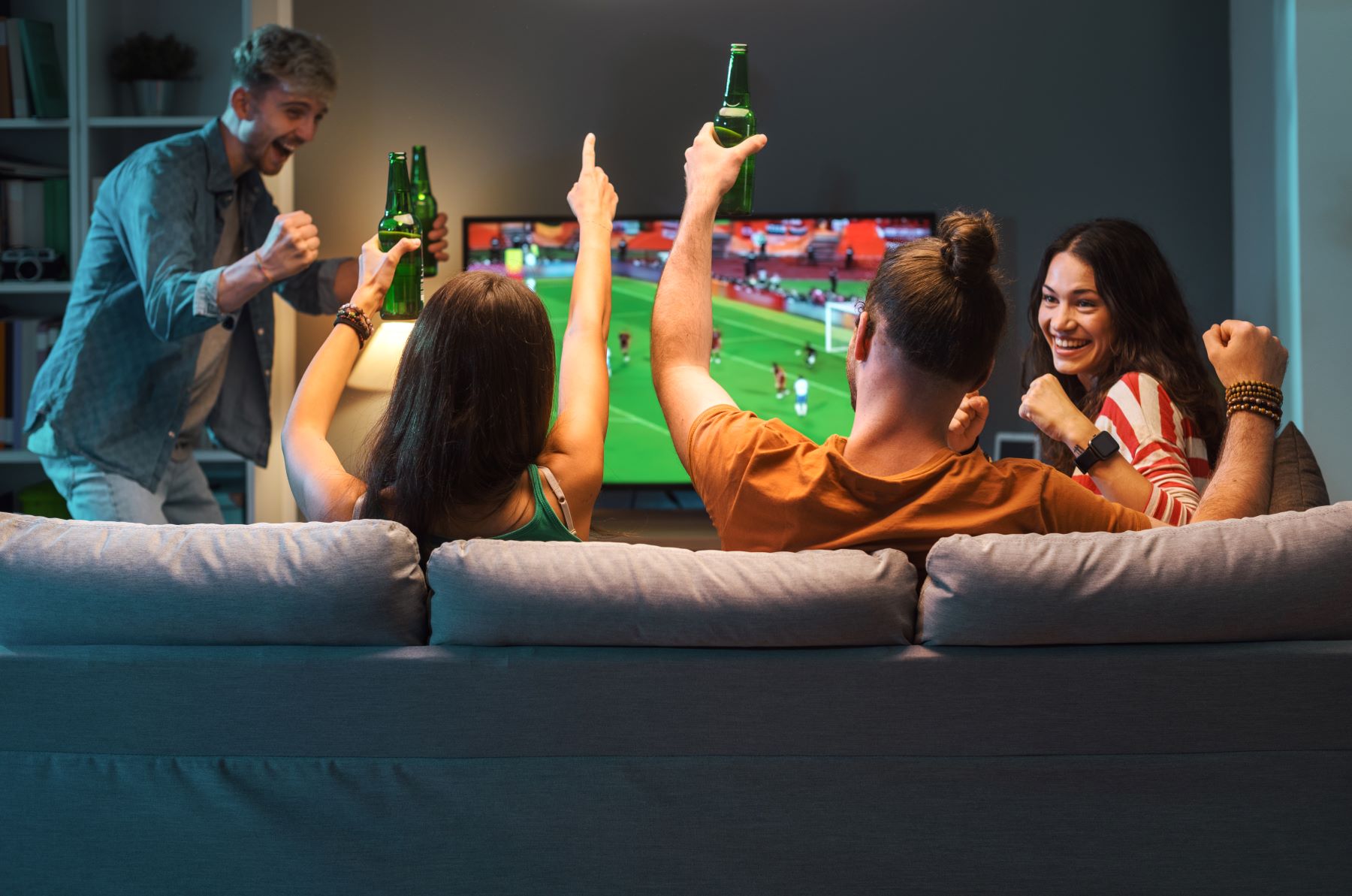 group of friends watching a football match on tv