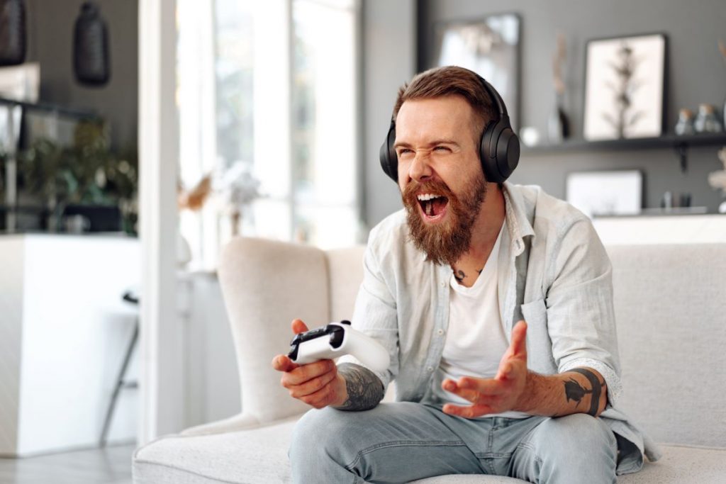 young bearded man playing video games