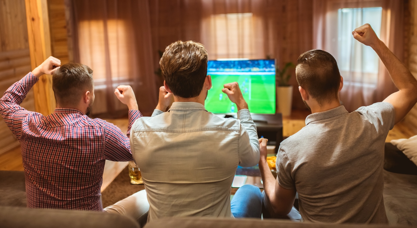 the-three-men-watch-a-football-game-and-cheer
