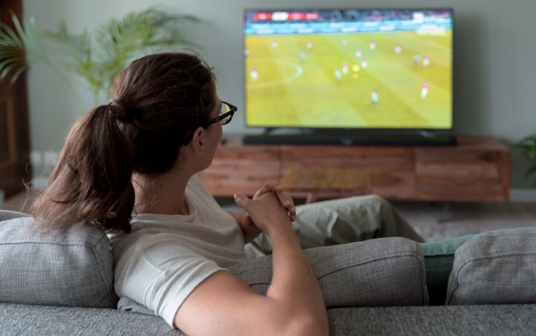 woman-watching-football-on-tv-at-home